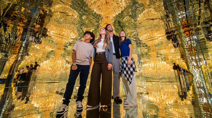 A family exploring the chandelier world at House of Hype